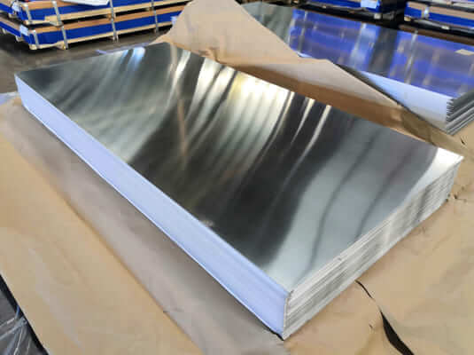 Stack of bare mill-finish aluminium sign panels at the Intrepid Signs shop in Rosenberg TX