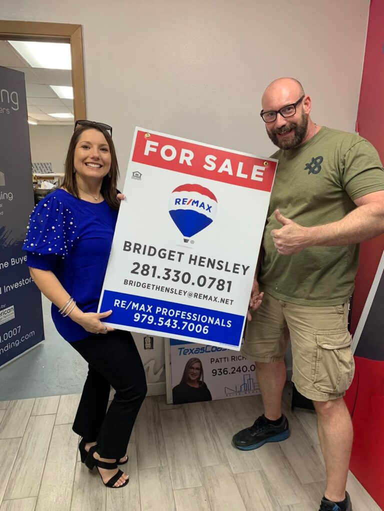 Customer Holding Sign we Made — Intrepid Signs, Rosenberg TX