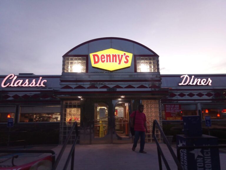 Lighted storefront sign illuminated at night in Texas