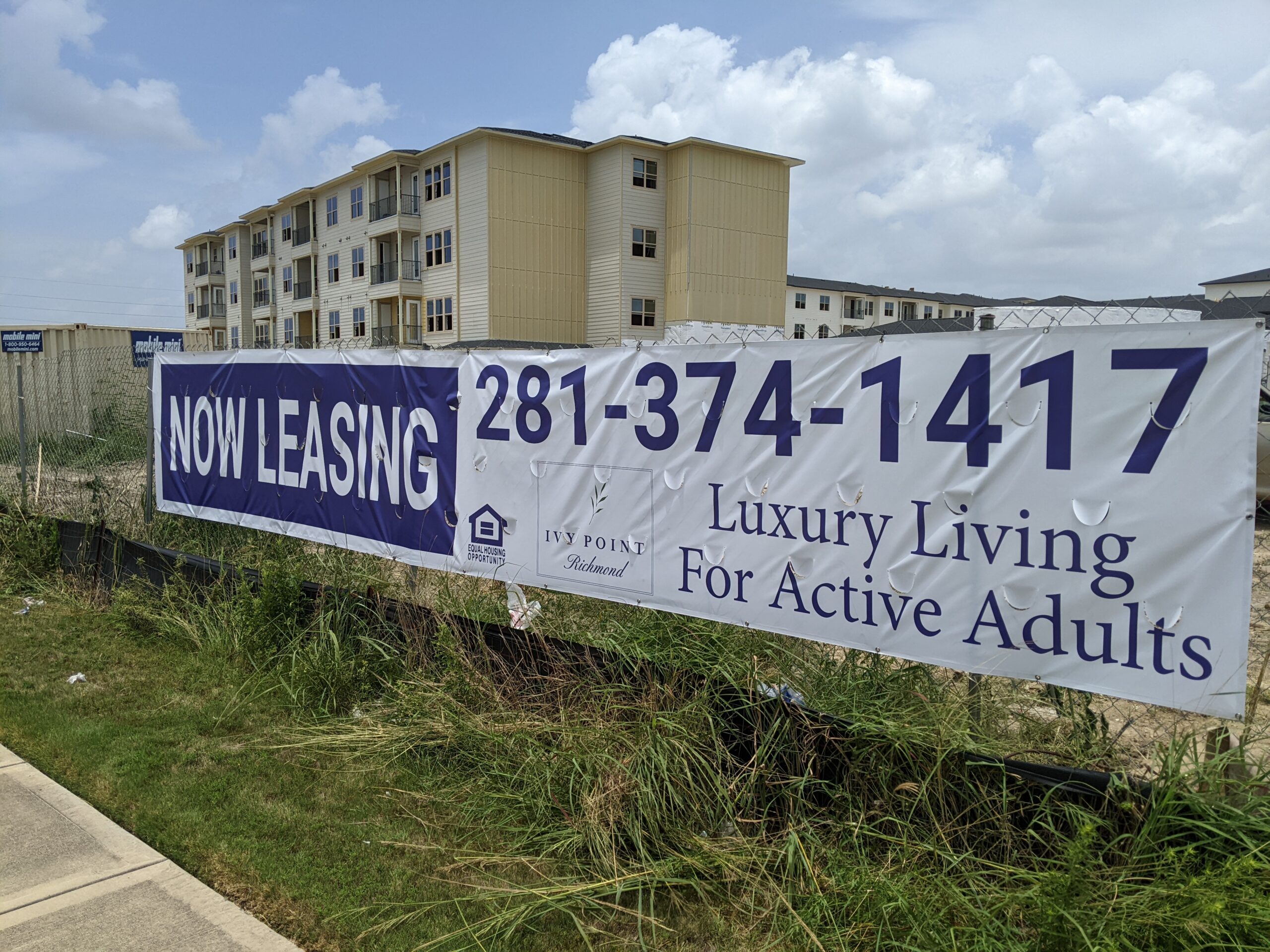 Now Leasing Banner on Fence — Intrepid Signs, Rosenberg TX
