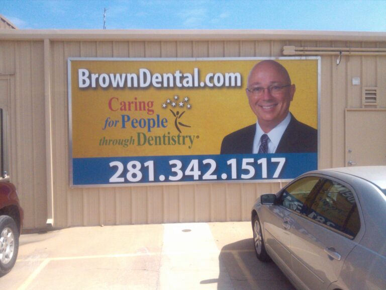 Brown Dental printed wall banner mounted on a building elevation