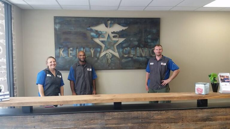 Three staff at a reception desk under a star sign — Intrepid Signs, Rosenberg TX